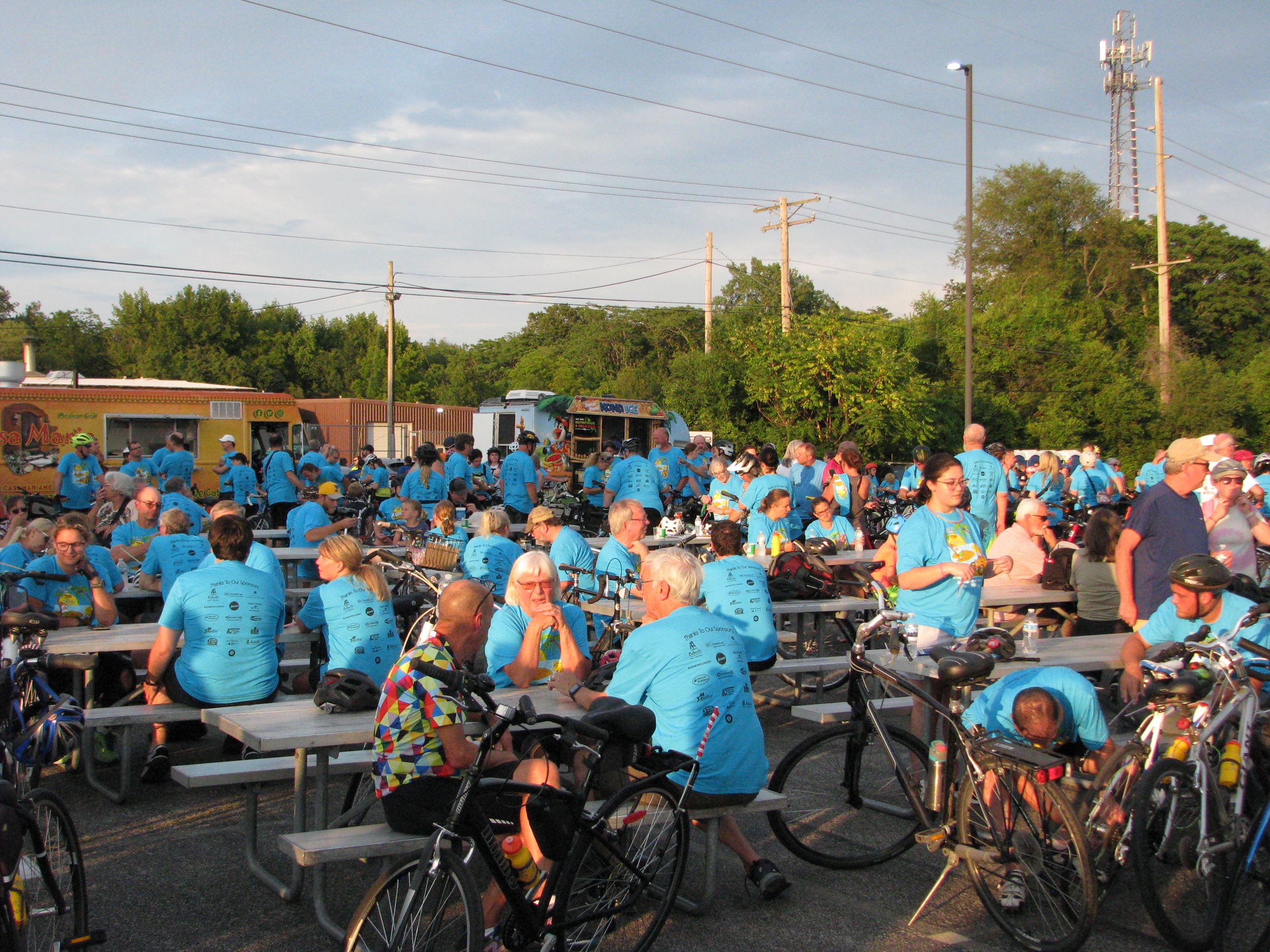 Many people mingling in Tour de Belleville shirts before the ride