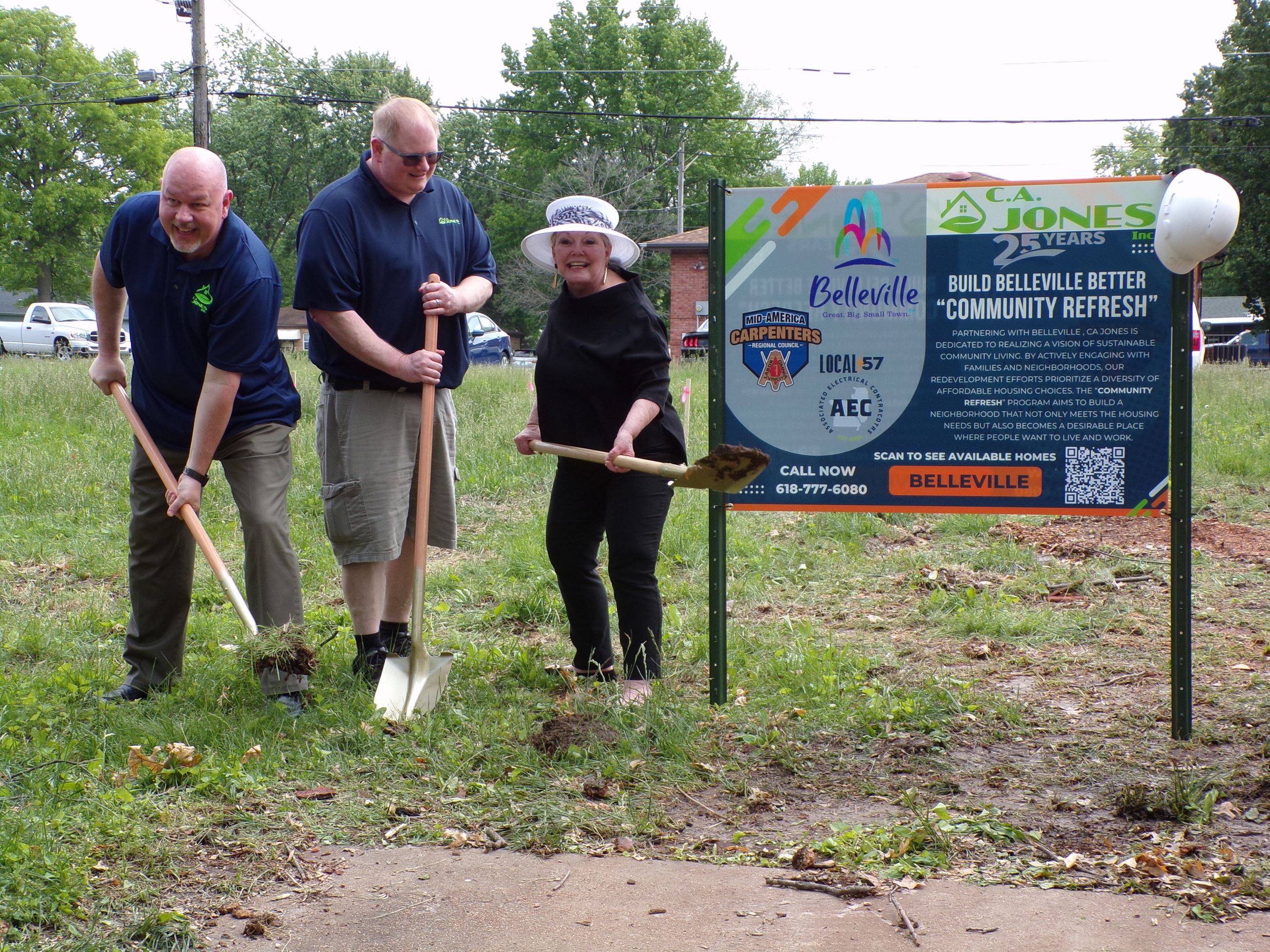 Rick Swain, Mike Needles, Belleville Mayor Patty Gregory break ground, holding gold shovels at lot